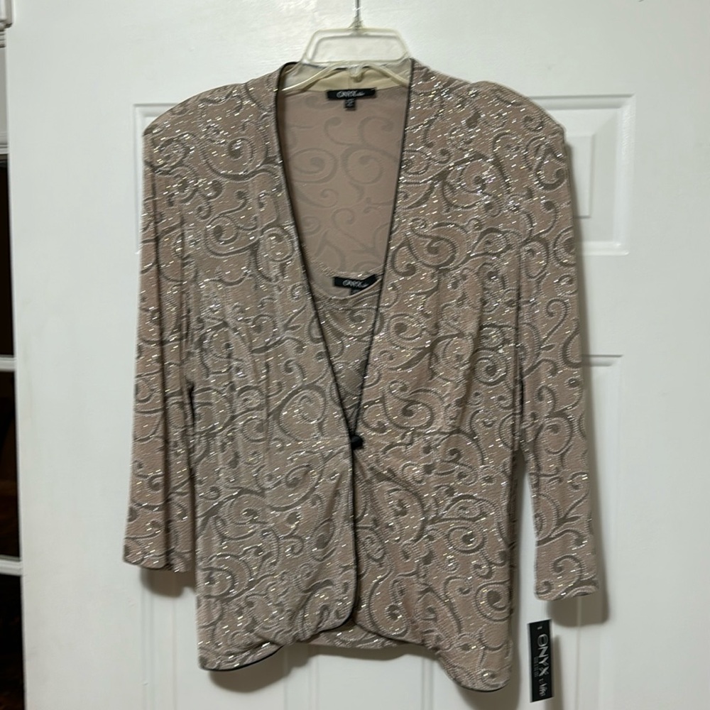 Beautiful sparkly two-piece top with three-quarter inch sleeves lightweight